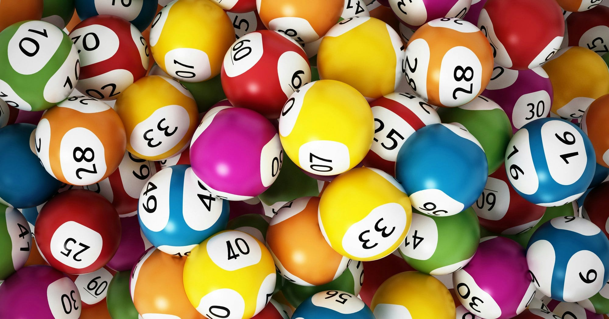 A colorful assortment of lottery balls, each with a number printed on it, piled together. The balls are in various colors including red, blue, yellow, green, and orange.